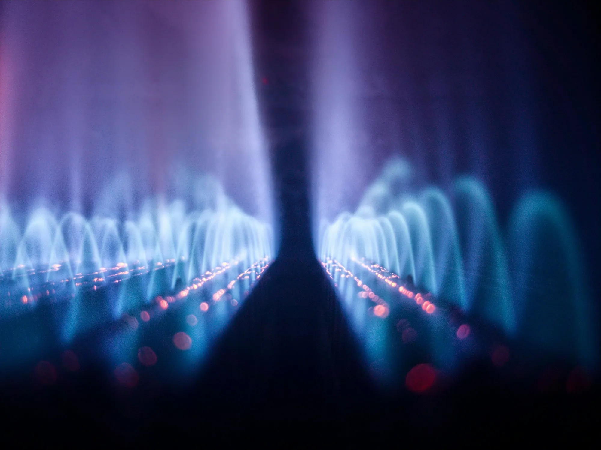 Row of blue gas burner flames inside a furnace